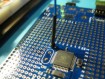 Detail of connecting an external clock source to the XI pin of a Parallax Propeller Proto Board with external crystal removed